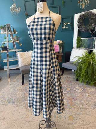 Blue and white checkered dress on a mannequin in a home setting with decor elements.